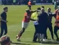 York player punches Rochdale fan during chaotic pitch invasion that cost them promotion